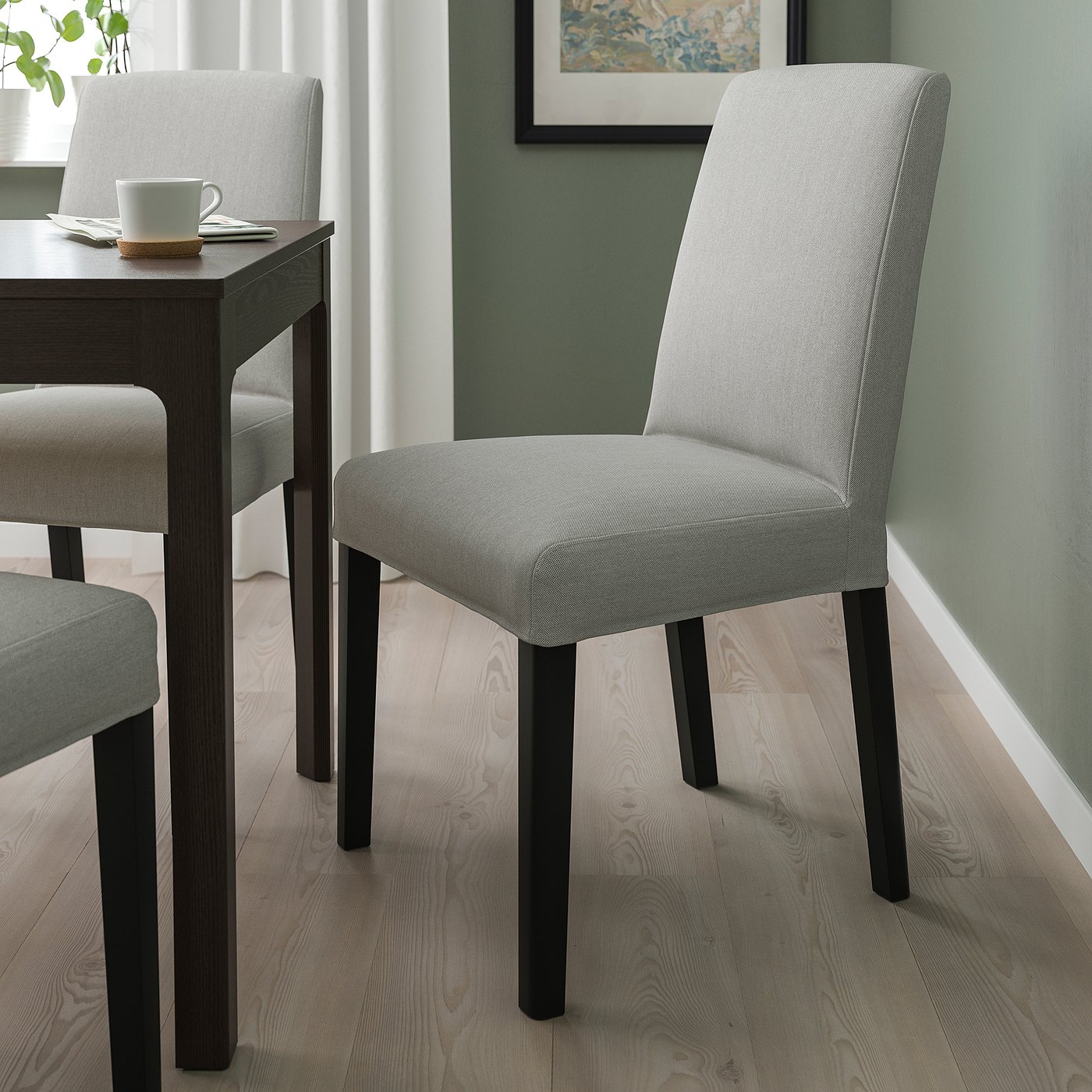 Modern dining setting with grey BERGMUND chair, dark table, light wood floor.