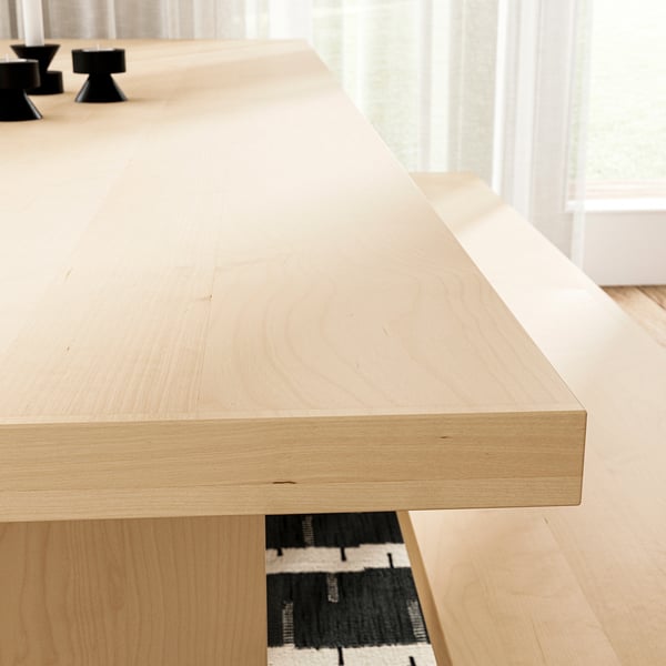Light wood table, smooth surface, minimalist design. Positioned indoors, reflects craftsmanship and quality.