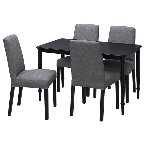 Black rectangular dining table with four grey upholstered chairs; modern minimalist design.