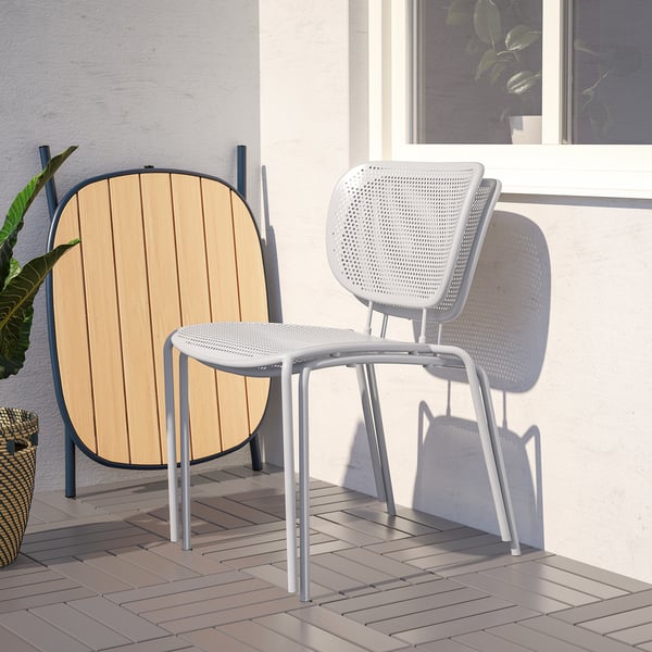 Modern DUVSKÄR chairs, one with wood back, on patio.