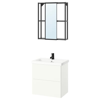 Modern white bathroom vanity with black tap and rectangular black-framed mirror.
