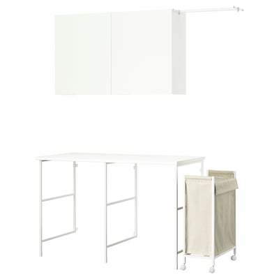 White IKEA ENHET laundry set with table, wall unit, and beige hamper.