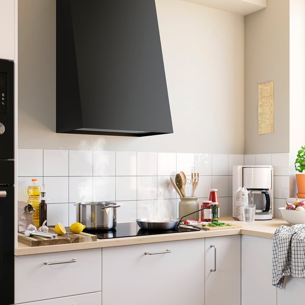A modern kitchen with a large, sleek black FIVELSBO range hood. White cabinets, countertop with a pot, pan, and various cooking utensils.