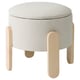 Round grey upholstered stool with light wood legs, perfect for extra seating or storage.