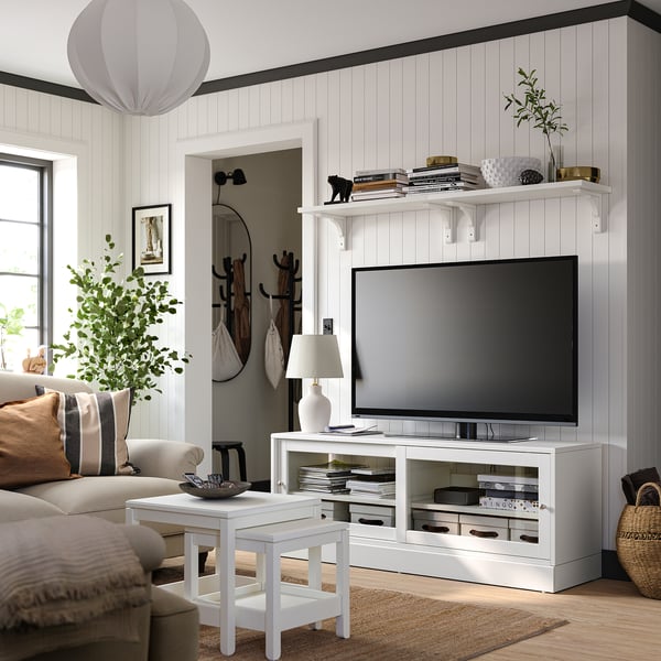 Modern living room with white HAVSTA tv stand, flat screen tv, comfortable sofa, stylish decor, and natural light.