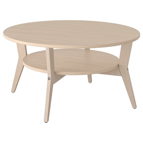 JAKOBSFORS round light wood coffee table, sleek design, three angled legs, shelf underneath.