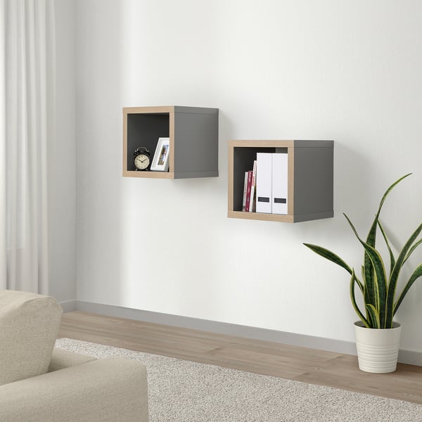 KALLAX shelves with clock, books, files. Modern design in living space with chair, rug, plant.