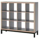 A KALLAX shelf unit in grey with light wood accents and black legs. It has a modular, cube-like design with open compartments.