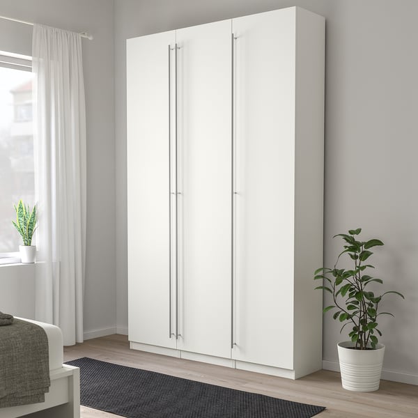 White KALLRÖR wardrobe in room with grey rug, curtains, plant.