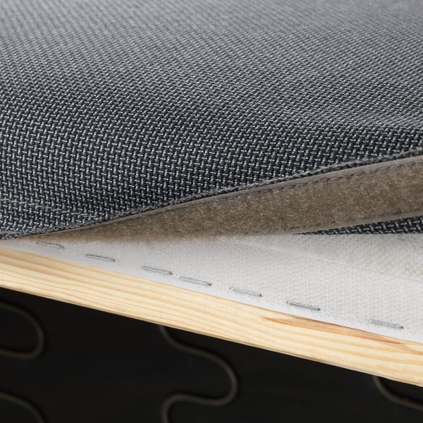 Close-up of sofa cushion edge showing fabric, foam, and stitching detail.