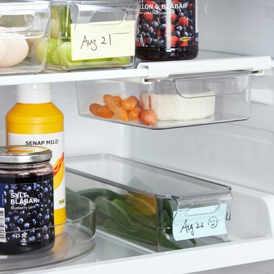 Fridge organiser trays store fruits, veggies, jams, keeping items visible and accessible.