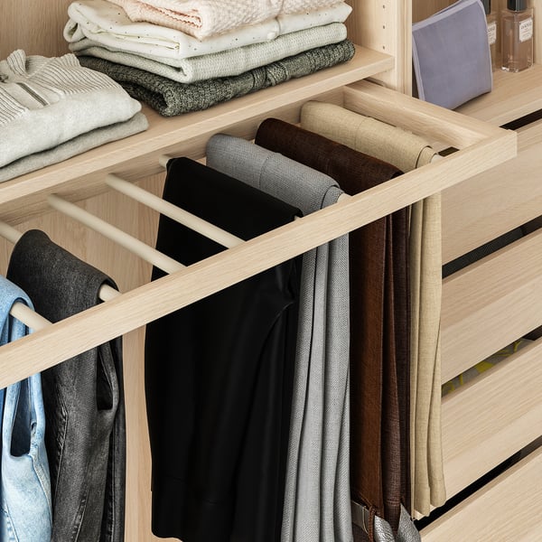Closet with rolled pants organiser and hanging sections. Zentrums of pants visible, efficient use of space.