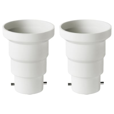 Two white plastic KOPPLA adapters convert b22 to e27 sockets, cylindrical with smooth design.