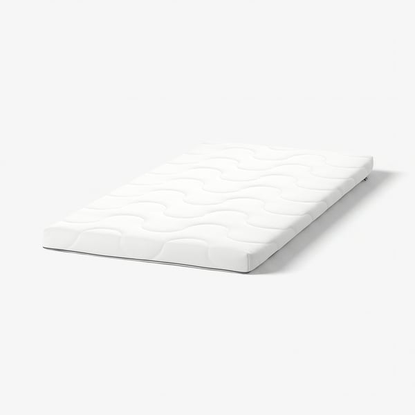 A white KRUMMELUR mattress designed for cots, firm with a wavy pattern, created from recycled polyester and polyurethane foam, zip safely enclosed.