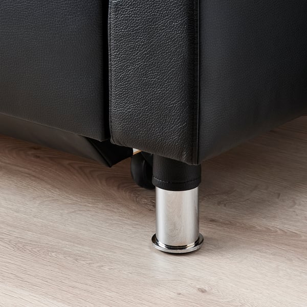 Modern sofa leg, chrome-plated metal, black base, contemporary design.
