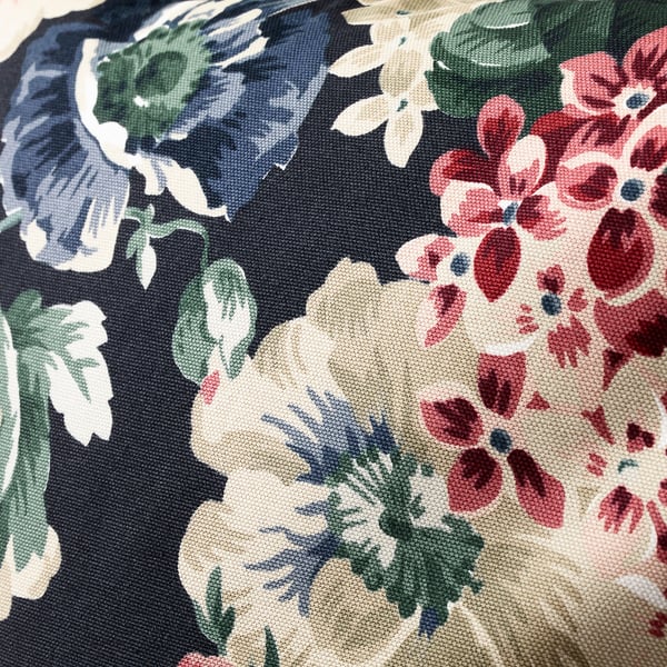 Floral cushion close-up: vibrant flowers, dark background, intricate details, high-quality cotton.