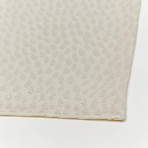 Folded white tablecloth, intricate textured pattern, pristine quality.