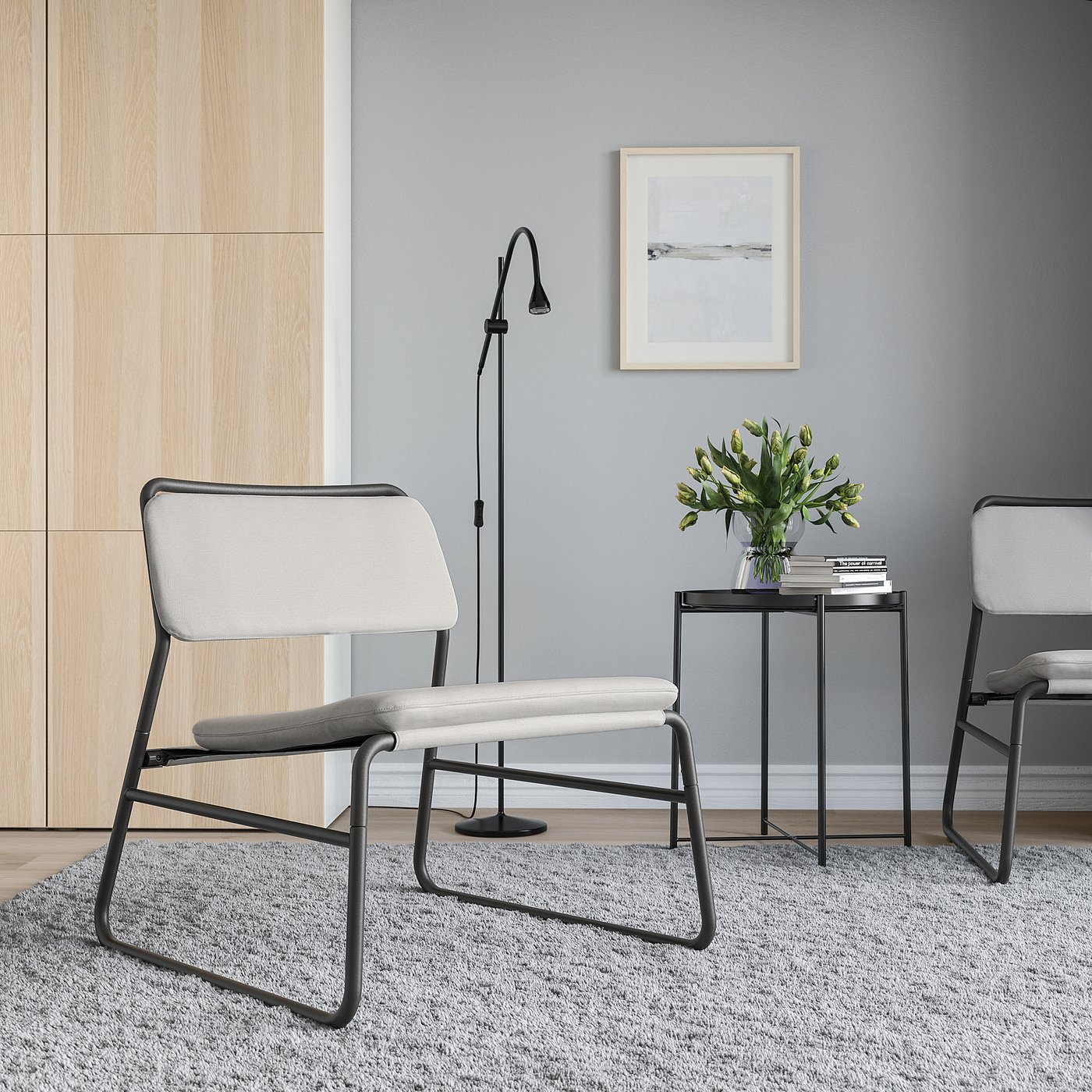 Modern living room with LINNEBÄCK chairs, side table, rug, lamp, and artwork.