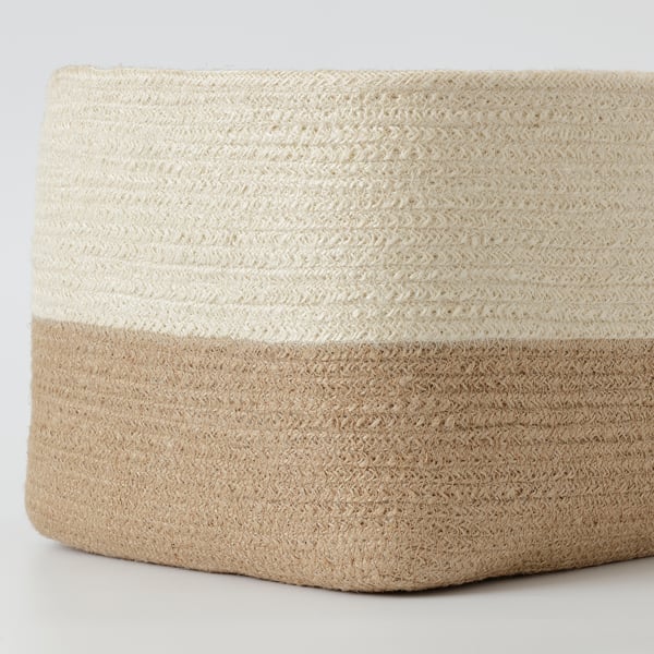 Crafted woven basket, natural & bleached jute, hand-braided, sturdy texture, ideal for home organisation.