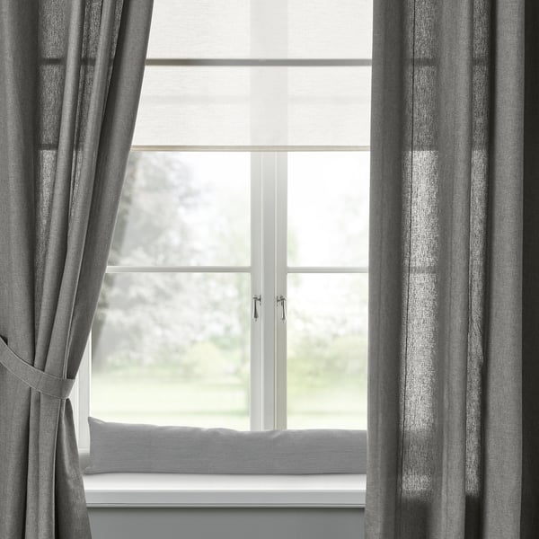 Grey LJUNGSNÄRJA curtains on large window with tree view.