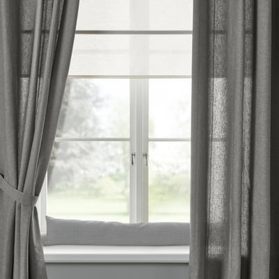 Grey LJUNGSNÄRJA curtains on large window with tree view.