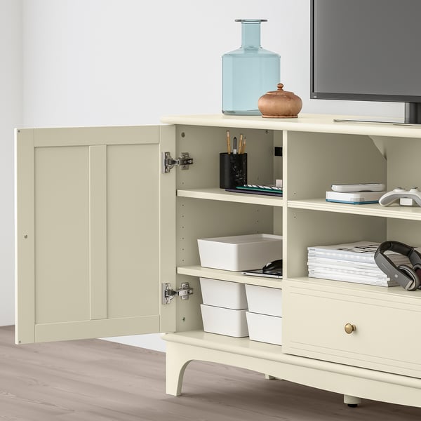 A white LOMMARP tv stand with adjustable shelves and storage boxes, with a blue vase on top.