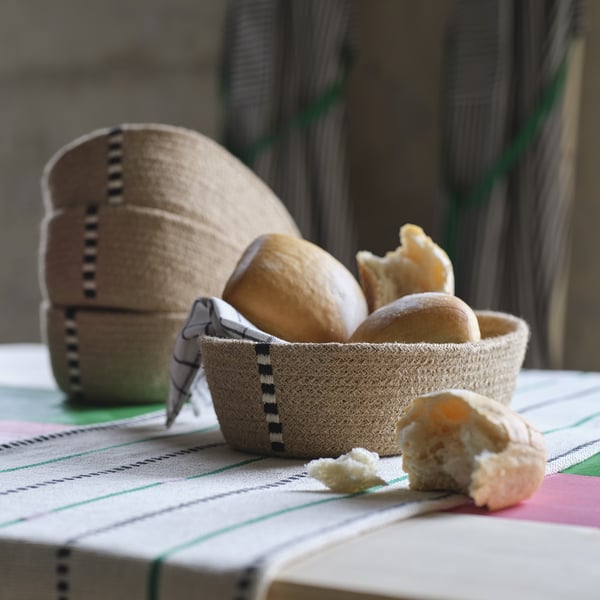 Basket on table with bread. Hand-embroidered jute, black & white stitching.
