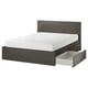 Black MALM bed with high headboard and four under-bed drawers, two pulled out. Modern, minimalist design.