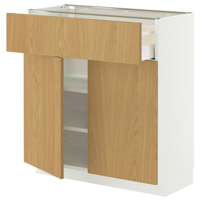 Modern kitchen cabinet, white and oak. Two adjustable shelves, medium drawer. Wood grain finish, metallic handles.