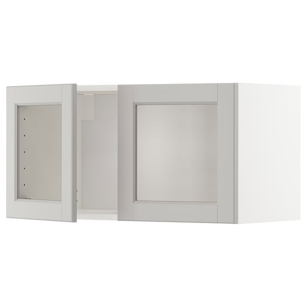 A white METOD kitchen cabinet with a light grey glass door.