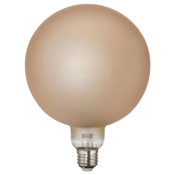Spherical light bulb, warm amber tone, glass cover, ikea brand, soft candlelight glow.