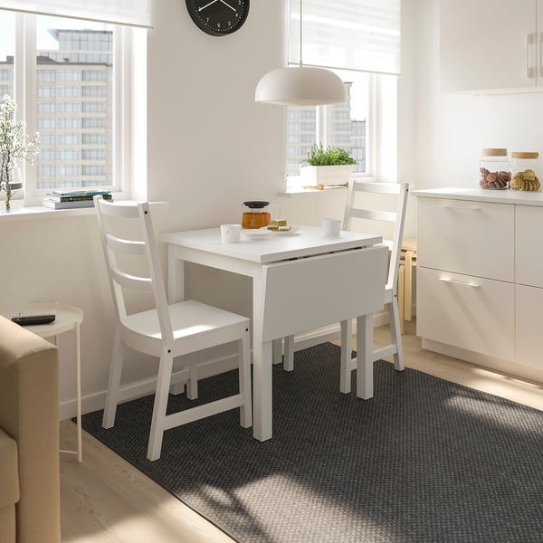 Small white NORDVIKEN dining set in compact space, with table, chairs, and simple decor.