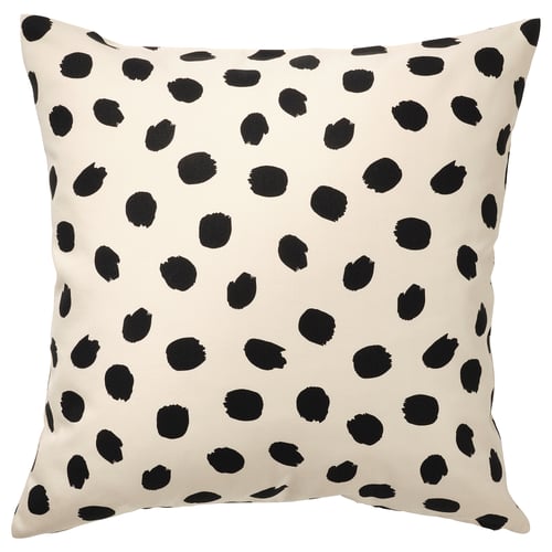 Square throw pillow, off-white with black dots, playful design.
