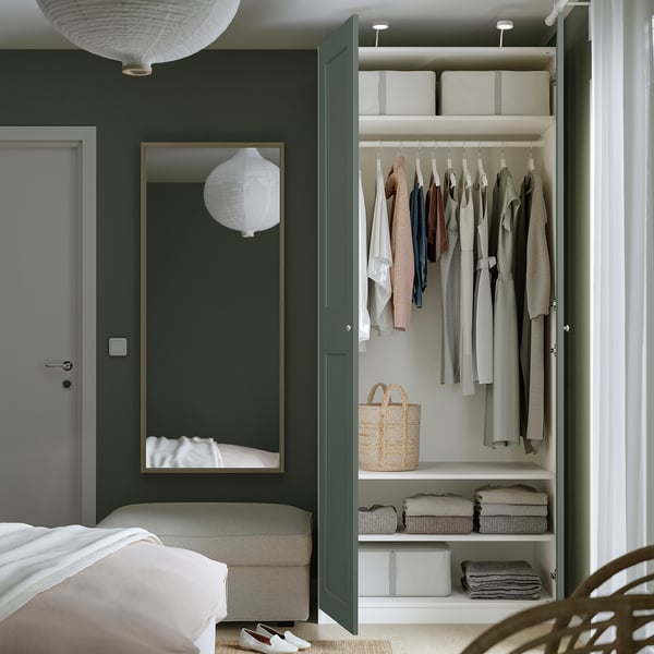 Close with clothes hangers, shelves, baskets, bed, mirror.