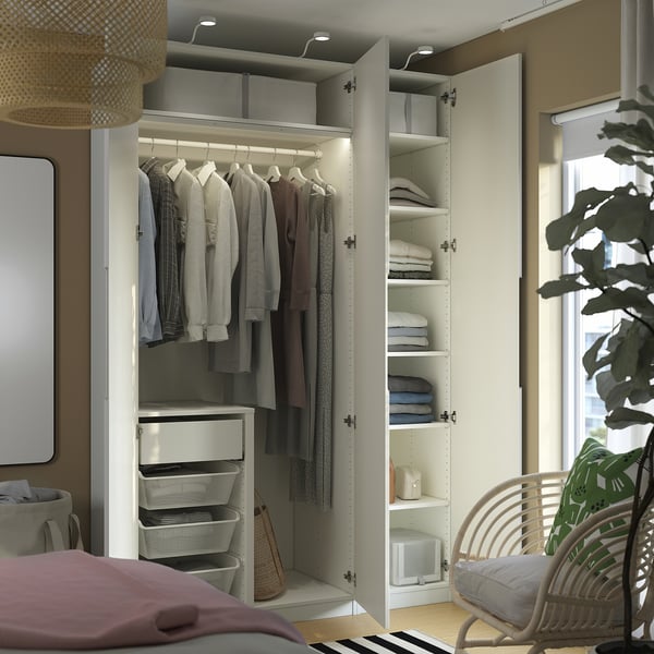 Organised PAX wardrobe with foldable clothes, stacked towels, and mesh baskets.