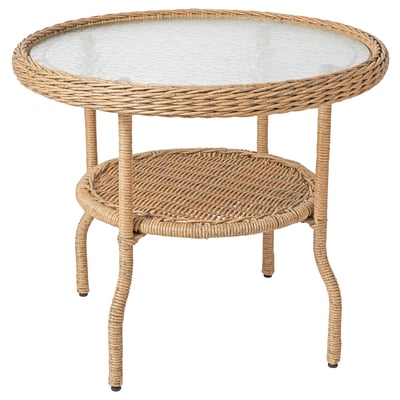 RISHOLMEN side table: beige, wicker & clear glass top, round, wavy legs, weather-resistant.