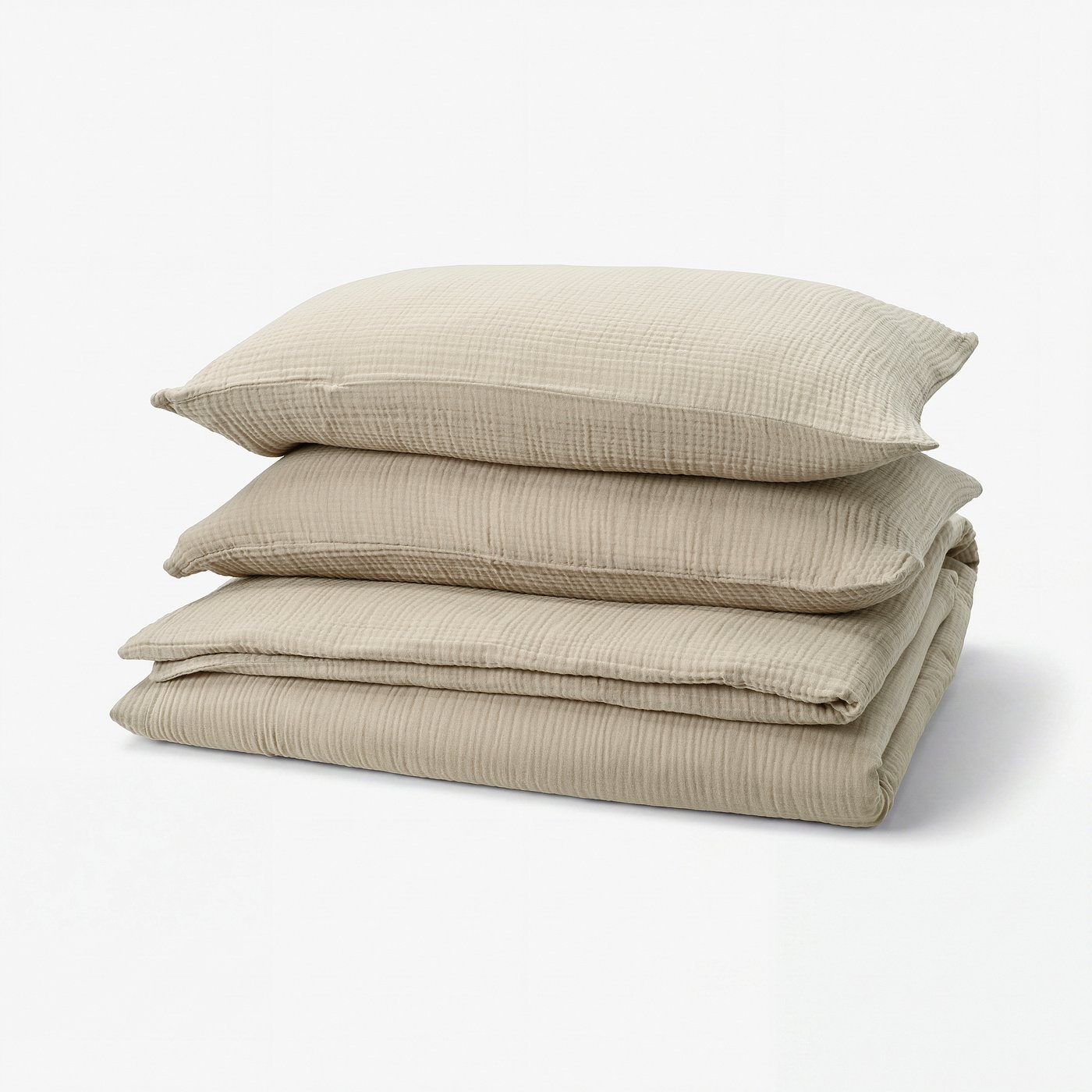 Three light beige, rectangular linen pillows stacked neatly.