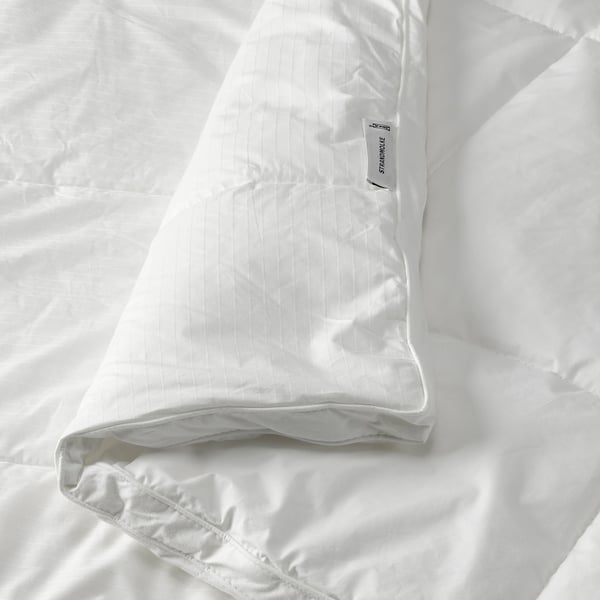 Luxurious white duvet with soft, dobby woven cotton, showcasing thick panel stitching for even warmth and comfort.