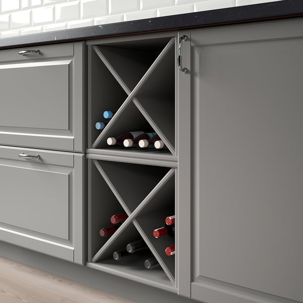 Kitchen cabinet with wine storage, displaying bottles.