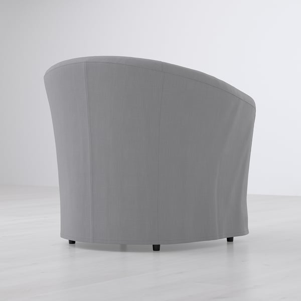 A sleek, small armchair with a curved back, designed for compact spaces. It a removable, machine-washable cover for easy cleaning.