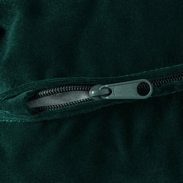 Dark green zip on suede-like material, showcasing smooth texture and durable design.