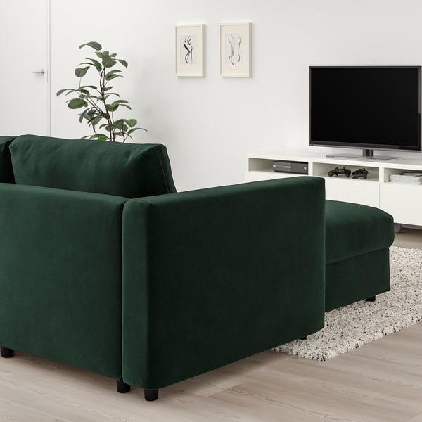 Modern living room with green VIMLE sectional sofa, tv stand, and minimalist decor.
