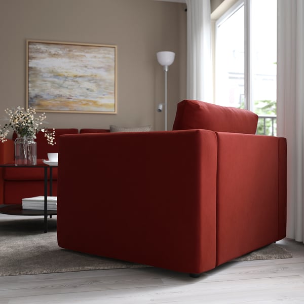 Red VIMLE sofa in cosy living room with flowers and art.