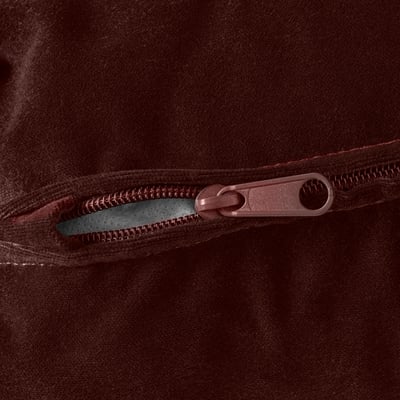 Close-up of brown zip on high-quality, suede-like fabric.