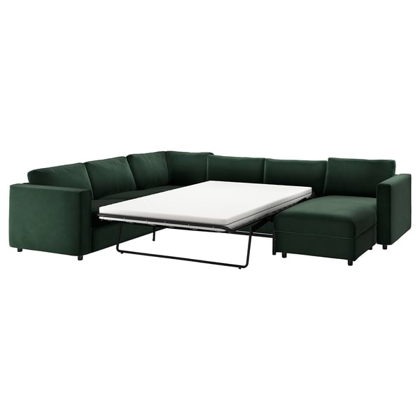 A green VIMLE sectional sofa with a pull-out bed in dark green fabric.