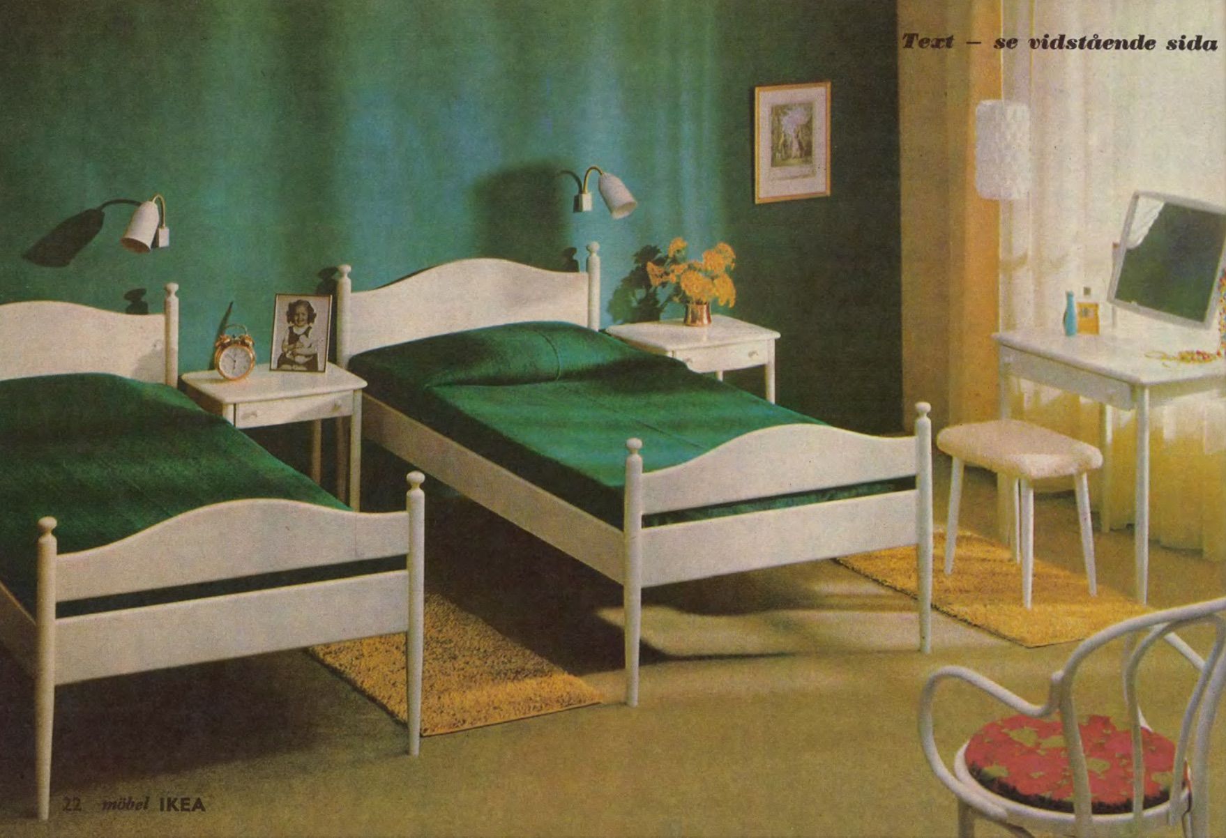 A green-walled bedroom room set from 1965 with two side-by-side single beds styled with green bed linen that matches the wall colour.