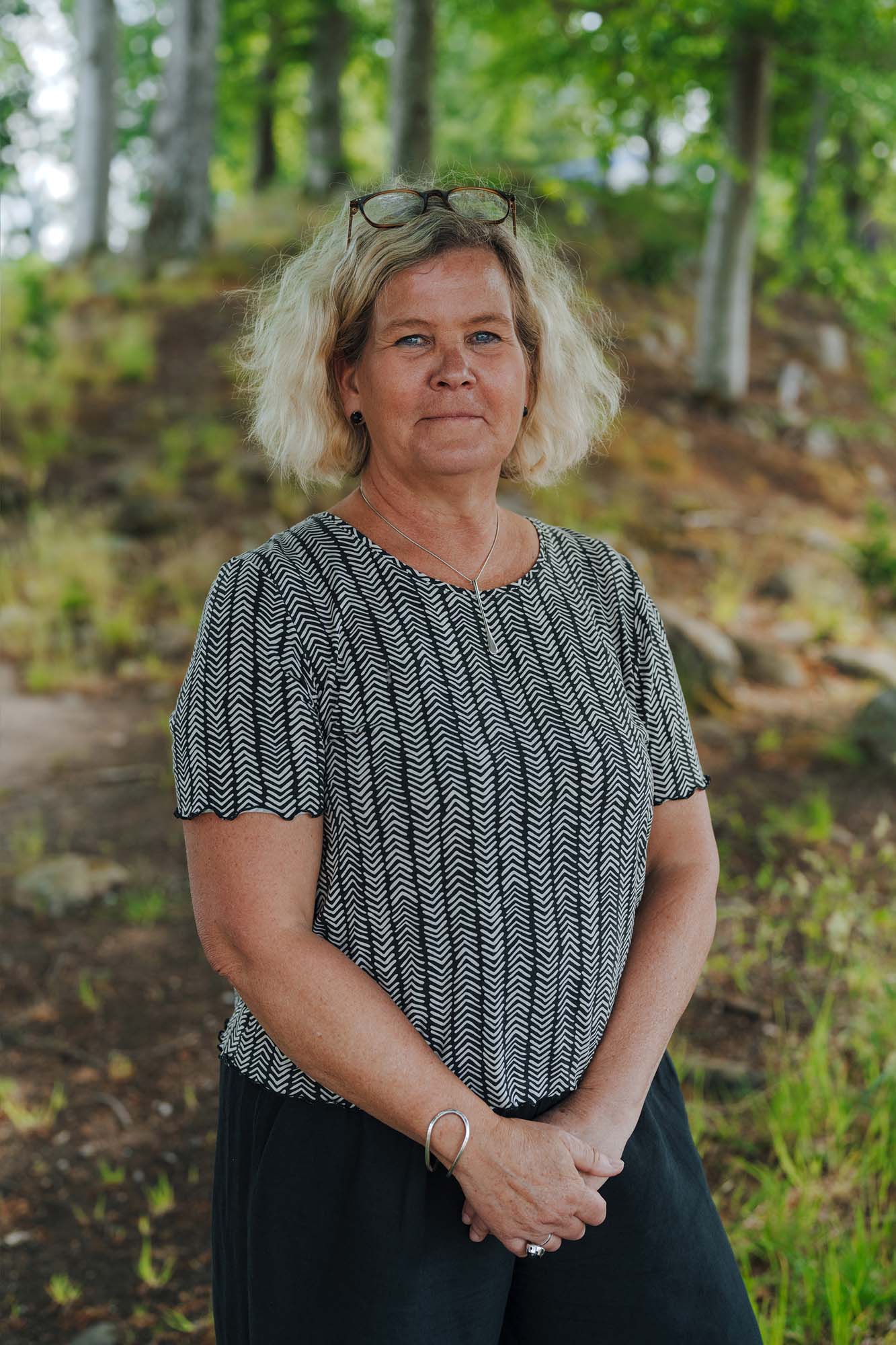IKEA co-worker Filippa stands in a wooded area and smiles at the camera.