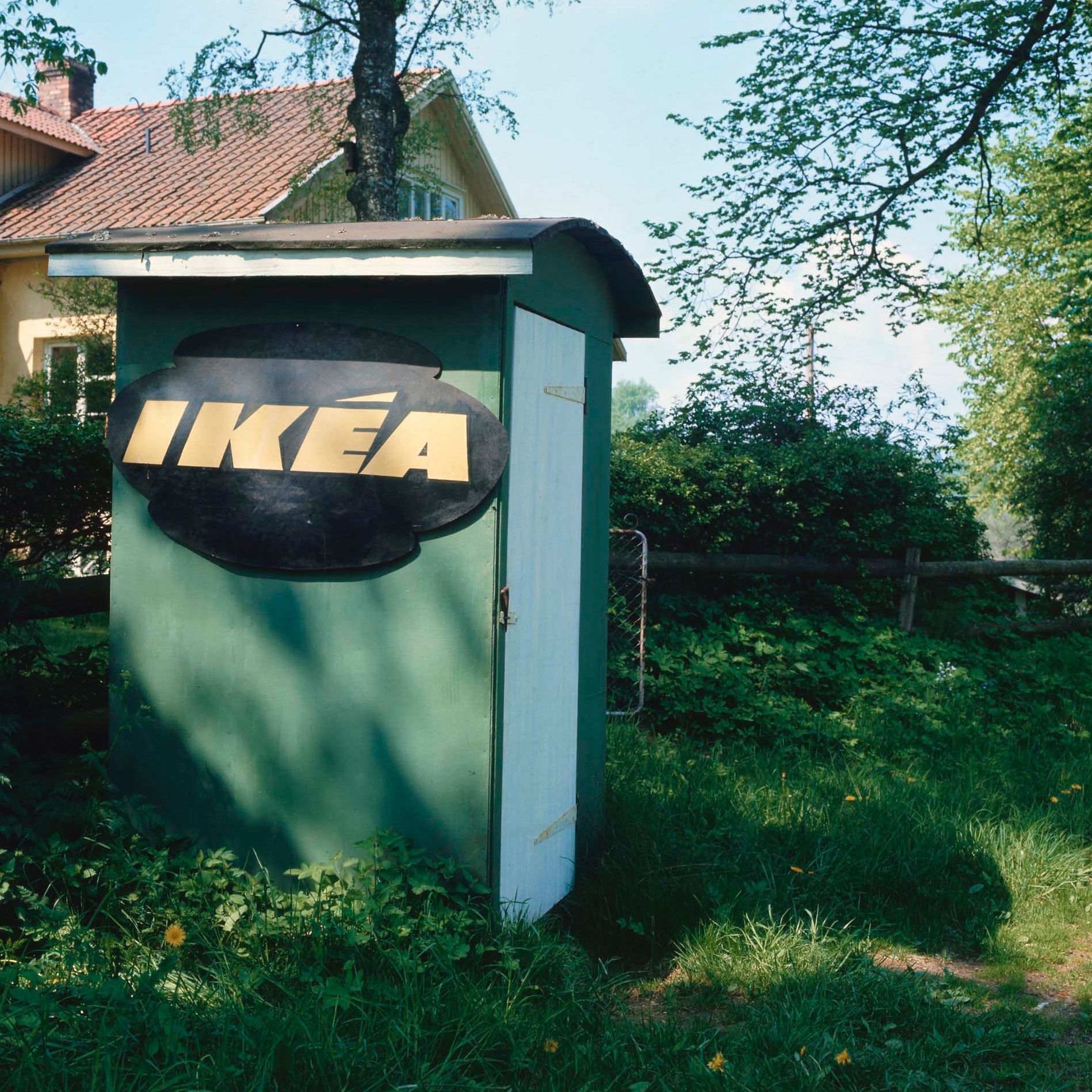 An old photograph of a small, green shed with the IKEA logo on the side.