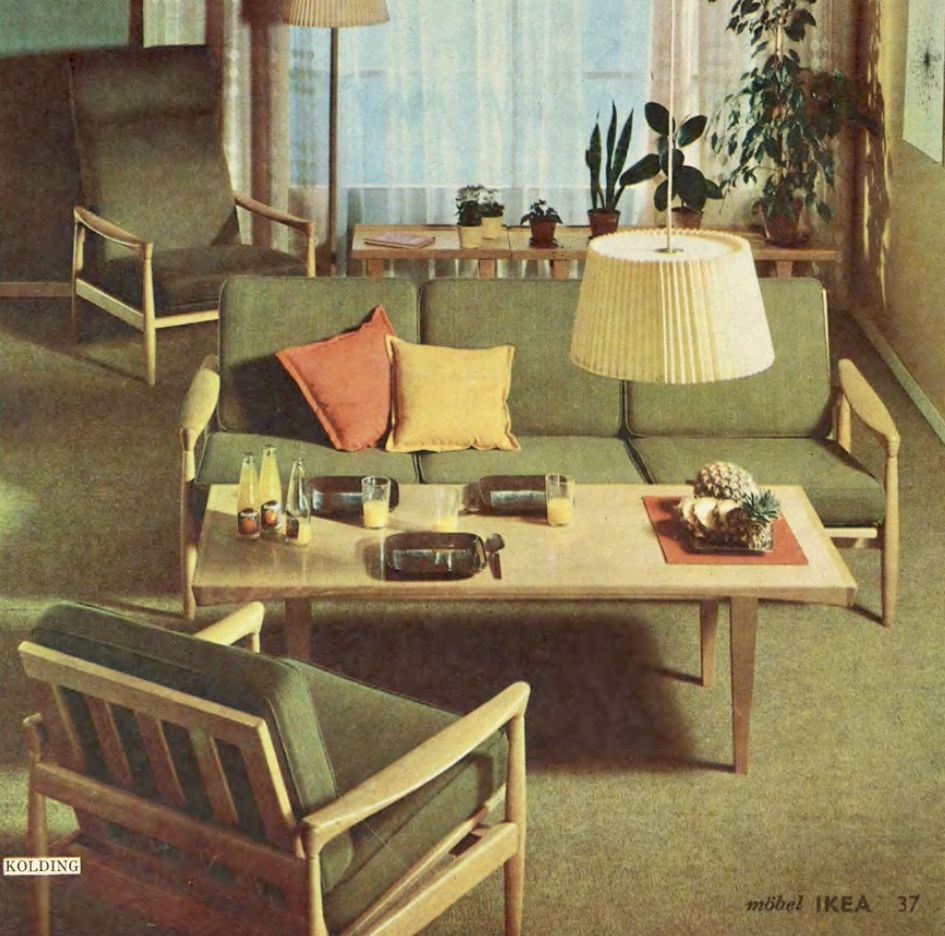 An all green living room with a sofa and chairs around a wood coffee table.