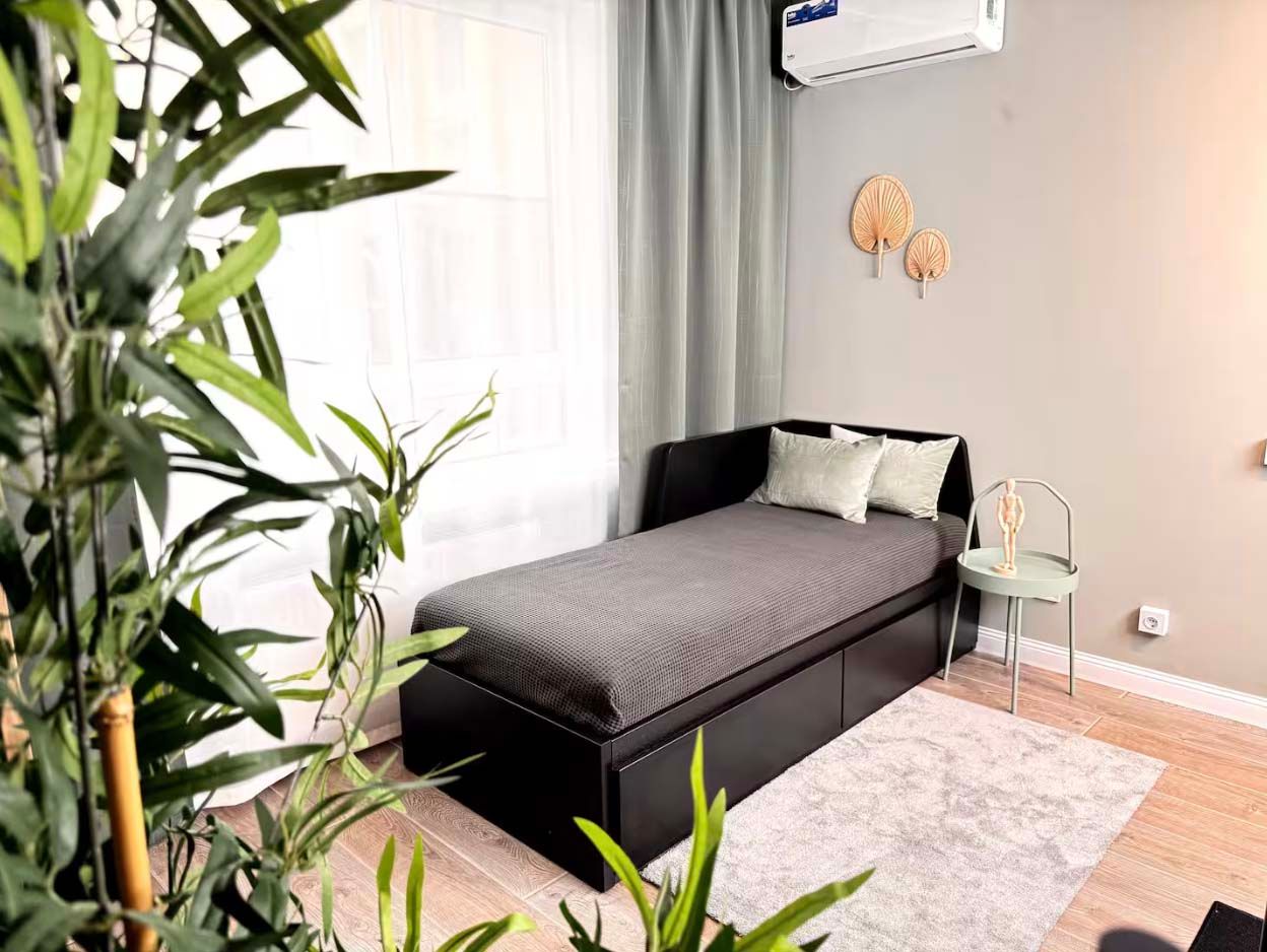 A living area with a single bed in the Stylish Design Apartments Airbnb in Almaty, Kazakhstan.